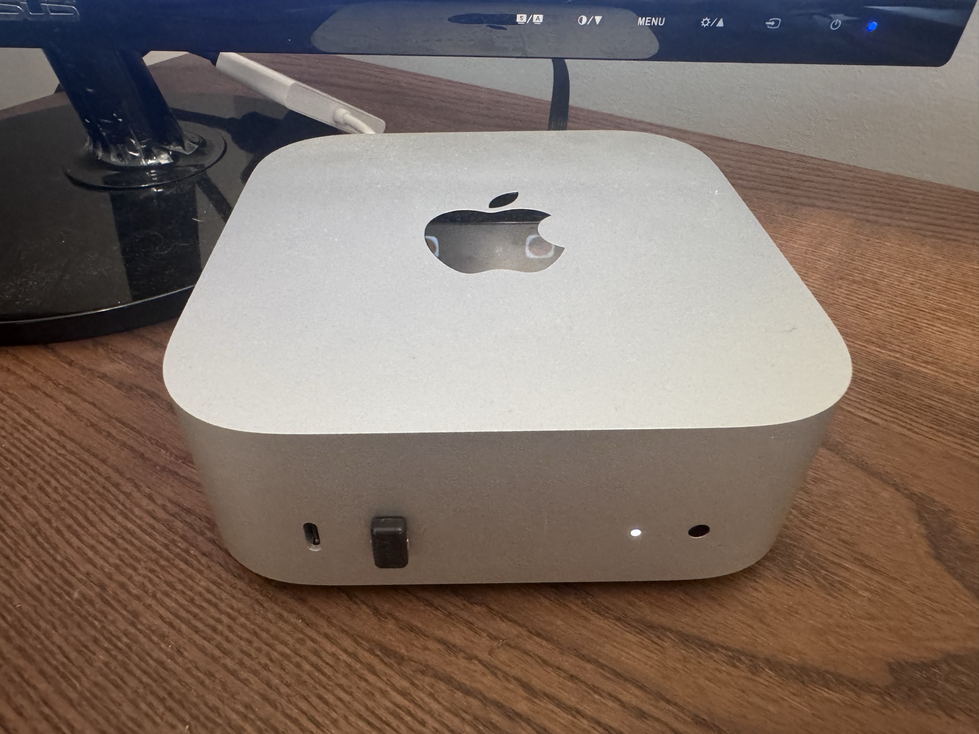The Mac mini sitting on a desk — the dedicated hardware that runs Rafiki, our AI teammate, 24/7